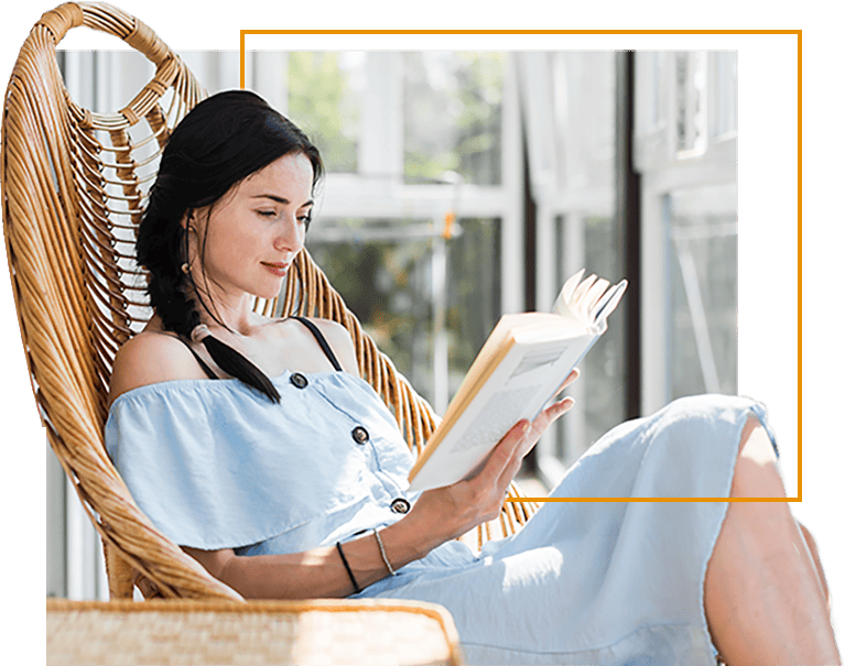 beautiful-young-woman-sitting-on-chair-reading-book